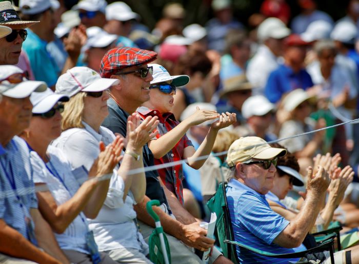 people watching golf and clapping