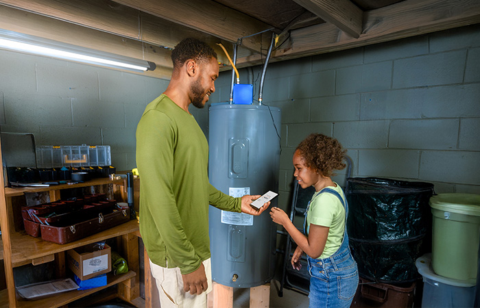 Girl and her dad setting water heater to avoid peak hours